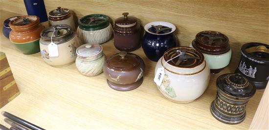 A Bourne Denby moulded tobacco jar and fifteen other tobacco jars, various (16)